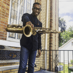 Scooter Brown, Jr. holding saxophone