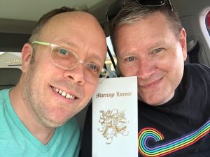 Matthew Kerns of St Lou Fringe and his husband with marriage license